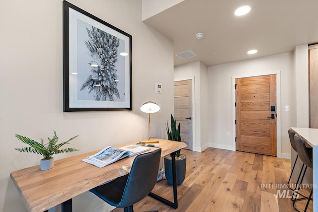 office with light hardwood / wood-style flooring