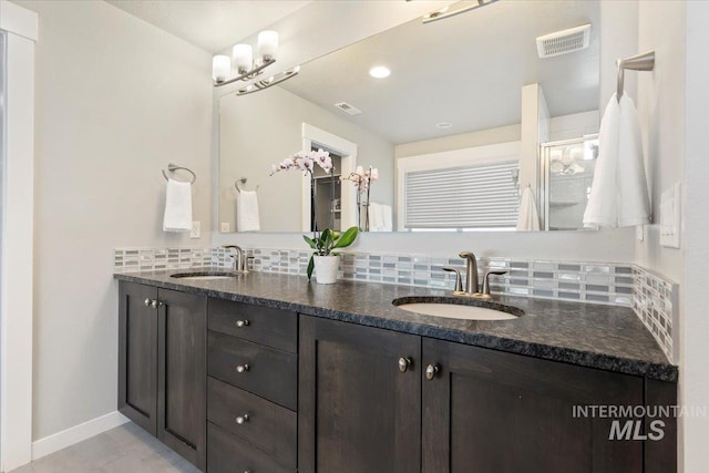 bathroom with tile patterned floors, backsplash, and vanity