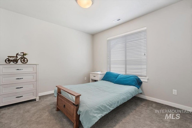 bedroom with dark colored carpet