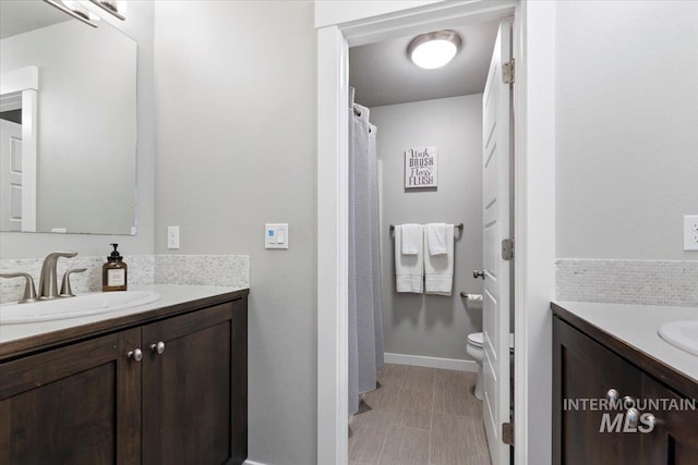 bathroom with toilet and vanity