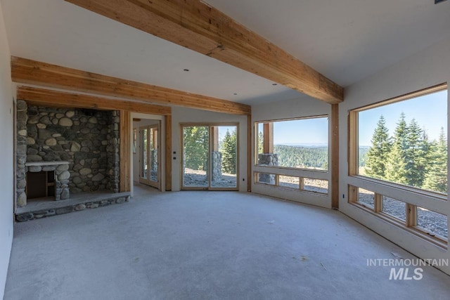 unfurnished sunroom with a stone fireplace and beam ceiling