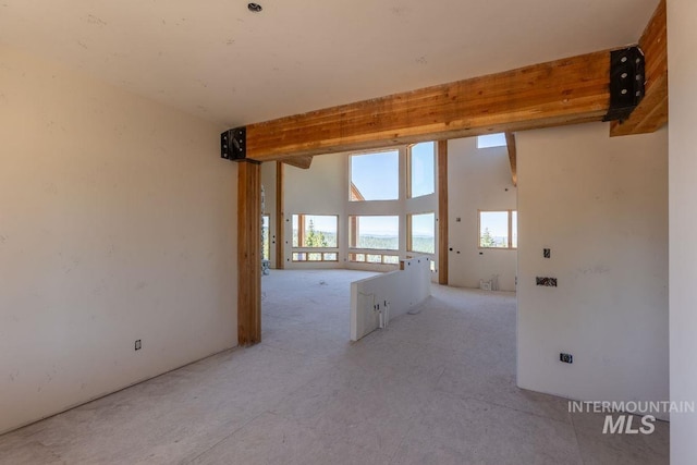 unfurnished room featuring a high ceiling