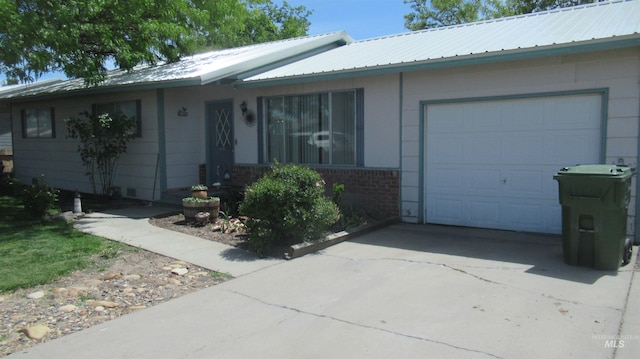 1112 W D St, Vale, OR 97918 - ranch-style house featuring a garage, concrete driveway, metal roof, and brick siding