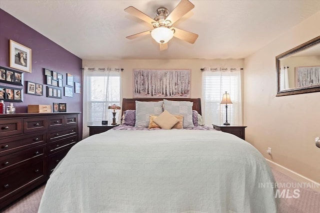 bedroom featuring light carpet and ceiling fan