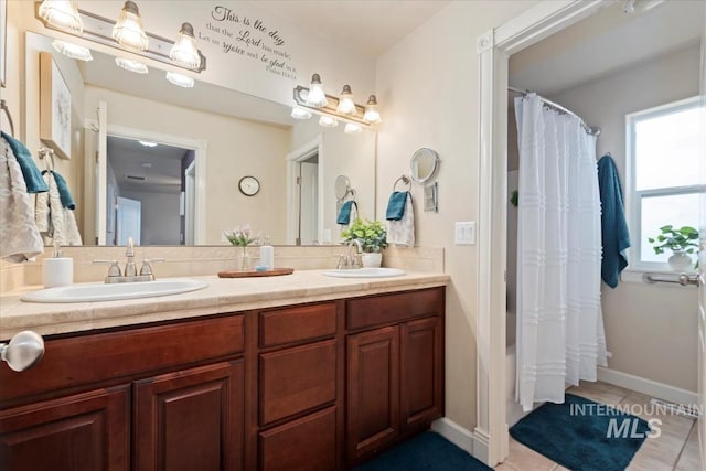 bathroom with tile patterned flooring, shower / bath combo, and vanity