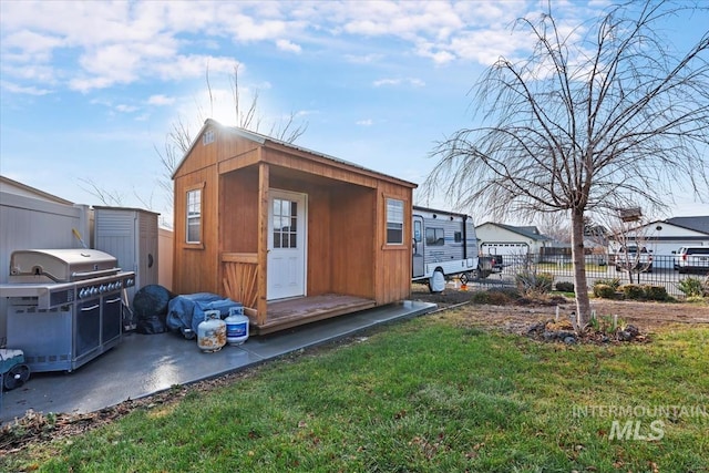 view of outbuilding with a lawn