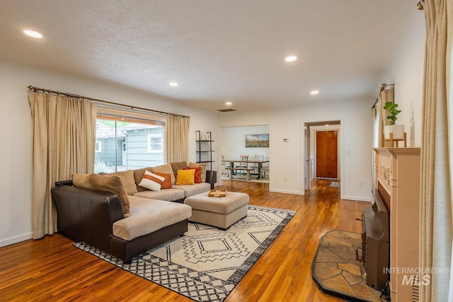 3102 N Sycamore Dr, Boise, ID 83703 - living area with wood finished floors, recessed lighting, baseboards, and a textured ceiling
