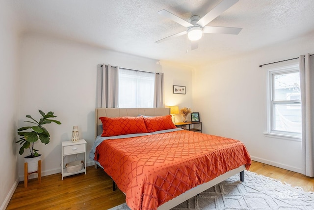 3102 N Sycamore Dr, Boise, ID 83703 - bedroom featuring wood finished floors, baseboards, a textured ceiling, and ceiling fan