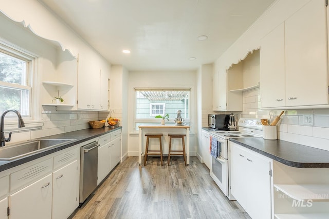 3102 N Sycamore Dr, Boise, ID 83703 - kitchen with open shelves, appliances with stainless steel finishes, a sink, dark countertops, and recessed lighting