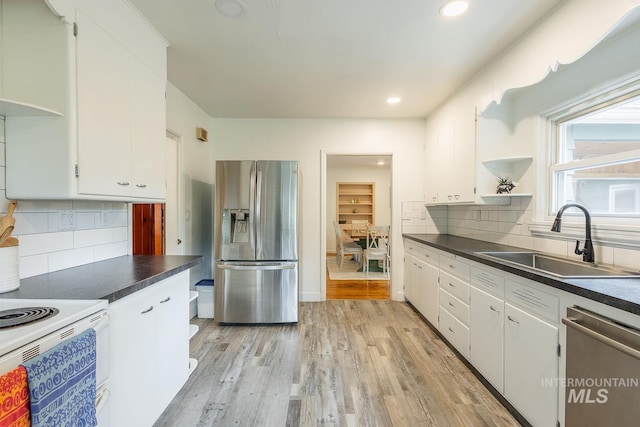 3102 N Sycamore Dr, Boise, ID 83703 - kitchen featuring appliances with stainless steel finishes, a sink, open shelves, dark countertops, and recessed lighting