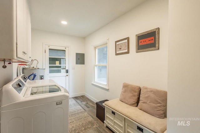 3102 N Sycamore Dr, Boise, ID 83703 - clothes washing area featuring washing machine and dryer, electric panel, water heater, cabinet space, and wood finished floors