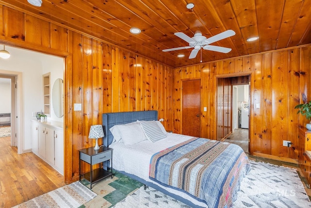 3102 N Sycamore Dr, Boise, ID 83703 - bedroom featuring wood ceiling, wooden walls, baseboards, light wood-style flooring, and washer / clothes dryer