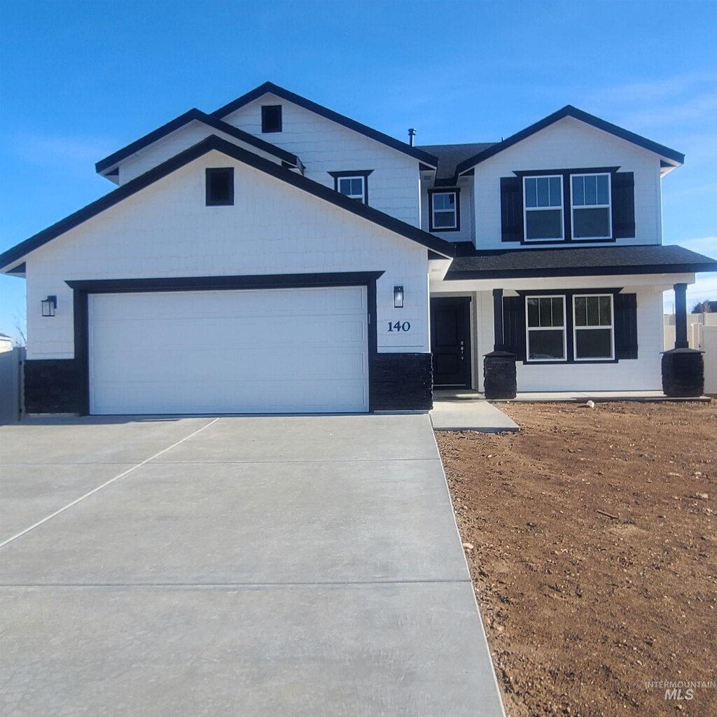 315 W Willow Dale Dr, Kuna, ID 83634 - view of front of home featuring driveway, a garage, and central AC