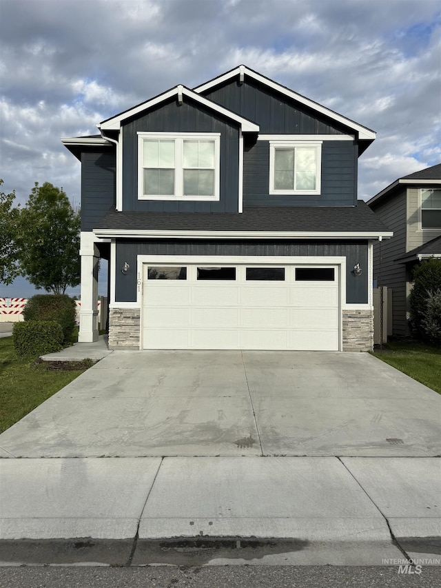 161 S Baraya Way, Meridian, ID 83642 - view of front of property featuring stone siding, an attached garage, concrete driveway, and board and batten siding