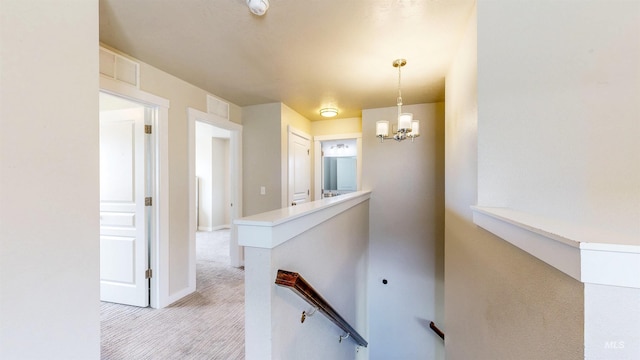 161 S Baraya Way, Meridian, ID 83642 - hallway with an upstairs landing, light carpet, a chandelier, and baseboards
