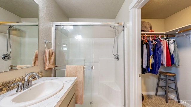 161 S Baraya Way, Meridian, ID 83642 - bathroom with a stall shower, a walk in closet, and vanity