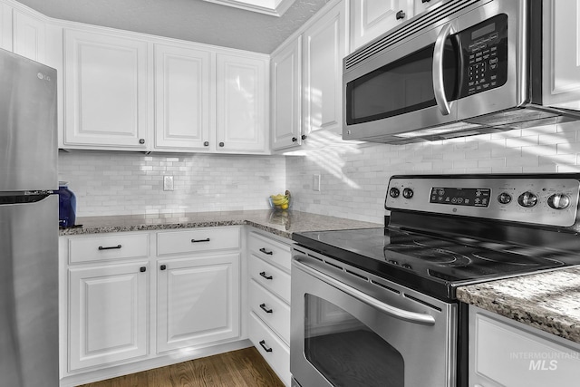 kitchen with appliances with stainless steel finishes and white cabinets