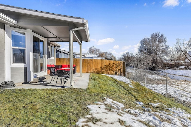 snowy yard featuring a patio