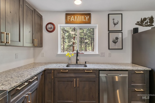 16 Grouse Rd, Idaho City, ID 83631 - kitchen with dark brown cabinets, light stone countertops, appliances with stainless steel finishes, and a sink