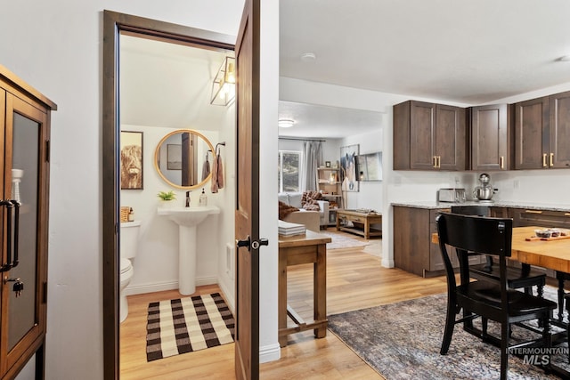 16 Grouse Rd, Idaho City, ID 83631 - interior space featuring dark brown cabinetry, baseboards, and light wood finished floors