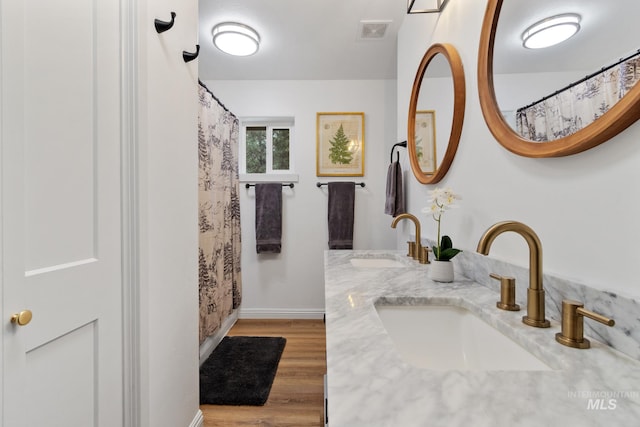 16 Grouse Rd, Idaho City, ID 83631 - full bath with baseboards, visible vents, a sink, and wood finished floors
