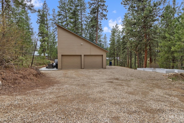16 Grouse Rd, Idaho City, ID 83631 - view of property exterior featuring dirt driveway, an outdoor structure, and a garage