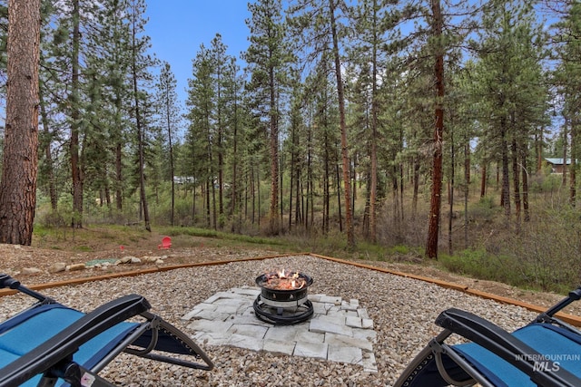 16 Grouse Rd, Idaho City, ID 83631 - view of yard with a forest view and a fire pit