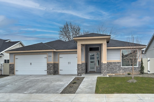 prairie-style house with a garage and a front yard