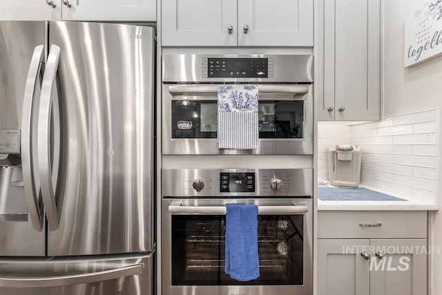 kitchen with backsplash and stainless steel fridge with ice dispenser