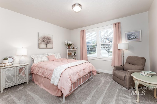carpeted bedroom with baseboards