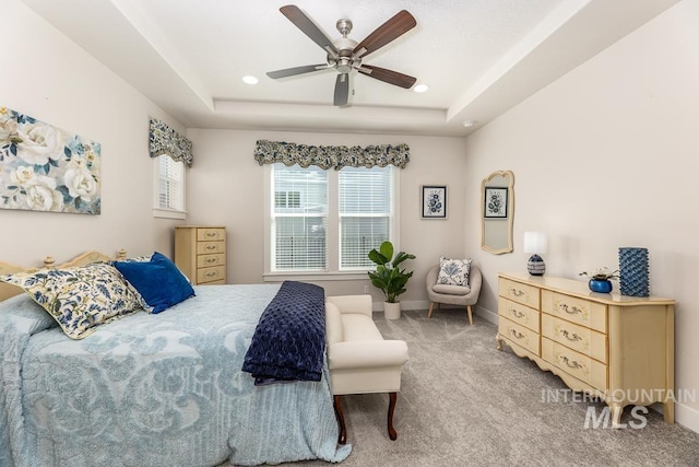 bedroom with baseboards, carpet flooring, recessed lighting, and a raised ceiling