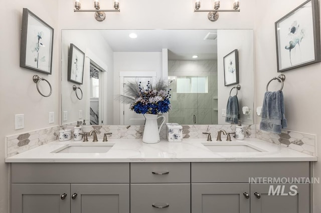 full bathroom featuring a shower stall, plenty of natural light, and a sink