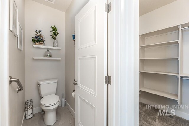 bathroom with visible vents, toilet, baseboards, and tile patterned floors