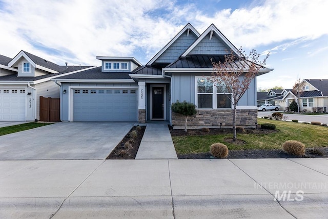 view of front of home with concrete driveway, stone siding, board and batten siding, and a garage