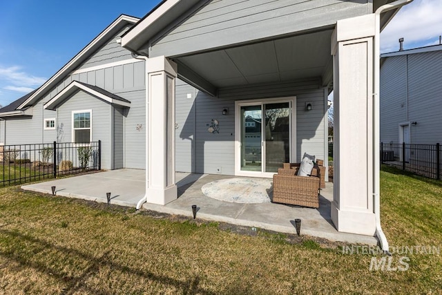 rear view of house featuring fence, a lawn, and a patio area