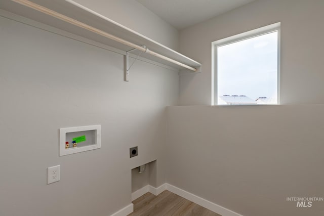 laundry room featuring laundry area, baseboards, hookup for a washing machine, hookup for an electric dryer, and light wood-type flooring