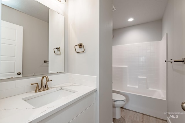 full bathroom featuring recessed lighting, bathtub / shower combination, toilet, vanity, and wood finished floors