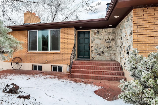 view of snow covered property entrance