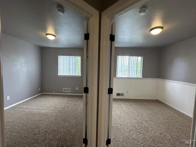 16928 N Chelford Loop, Nampa, ID 83687 - spare room featuring a textured ceiling, carpet, plenty of natural light, and a smoke detector
