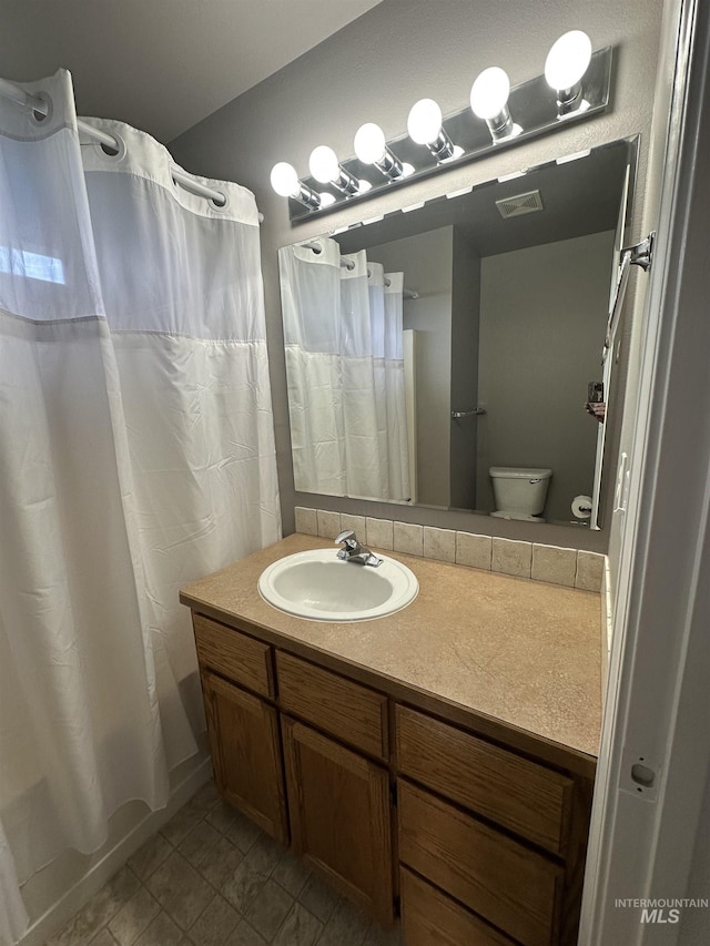 16928 N Chelford Loop, Nampa, ID 83687 - full bathroom featuring vanity, shower / bath combo with shower curtain, and toilet