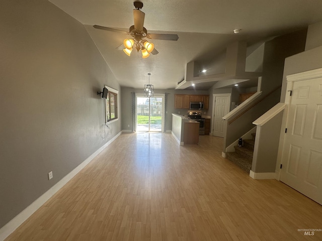 16928 N Chelford Loop, Nampa, ID 83687 - unfurnished living room featuring baseboards, light wood-style floors, lofted ceiling, and ceiling fan