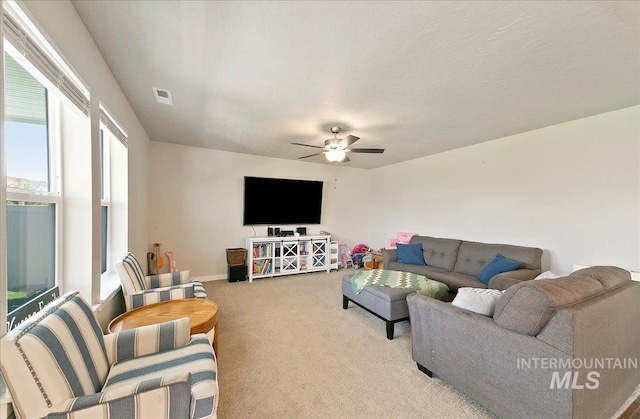 11299 W Taviton St, Nampa, ID 83651 - living room with light colored carpet, ceiling fan, and baseboards