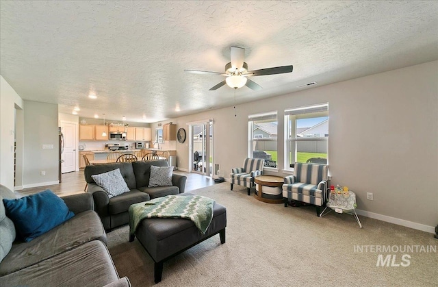 11299 W Taviton St, Nampa, ID 83651 - living area with a textured ceiling, ceiling fan, and baseboards