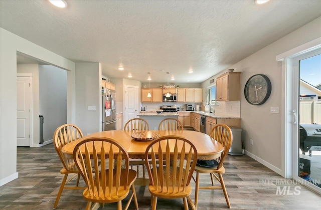 11299 W Taviton St, Nampa, ID 83651 - dining room featuring dark wood-type flooring, baseboards, plenty of natural light, recessed lighting, and a textured ceiling