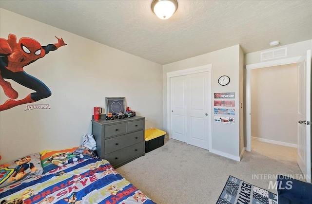 11299 W Taviton St, Nampa, ID 83651 - bedroom with light carpet, baseboards, a textured ceiling, and a closet