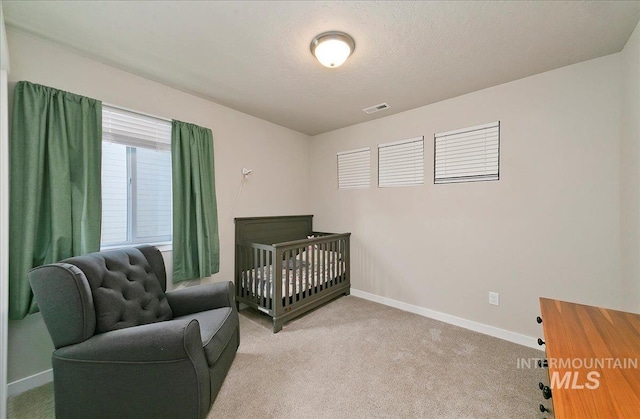 11299 W Taviton St, Nampa, ID 83651 - bedroom featuring light colored carpet, baseboards, and a nursery area