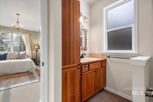 bathroom featuring a chandelier and vanity