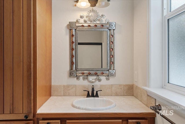 bathroom with vanity and a wealth of natural light