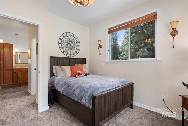 bedroom featuring carpet flooring and connected bathroom