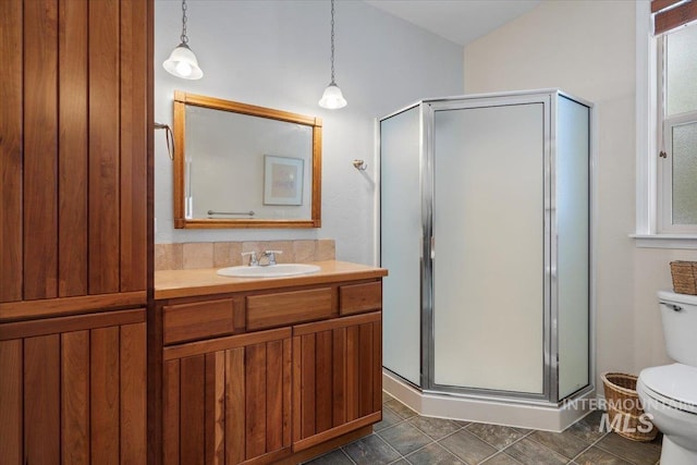 bathroom with vanity, toilet, and walk in shower